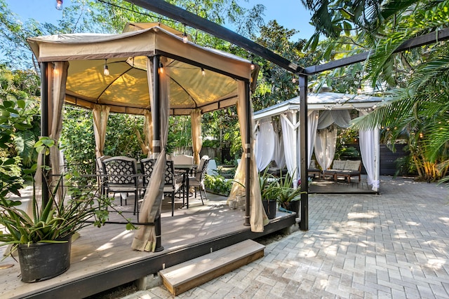 view of patio featuring a wooden deck and a gazebo