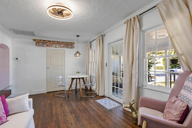 interior space with crown molding, dark hardwood / wood-style flooring, and a textured ceiling