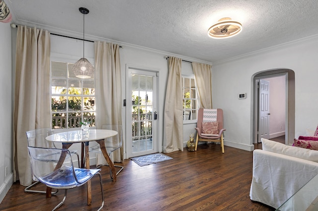 entryway featuring ornamental molding, dark wood-type flooring, and a textured ceiling