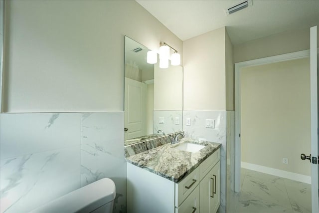 bathroom featuring vanity and toilet