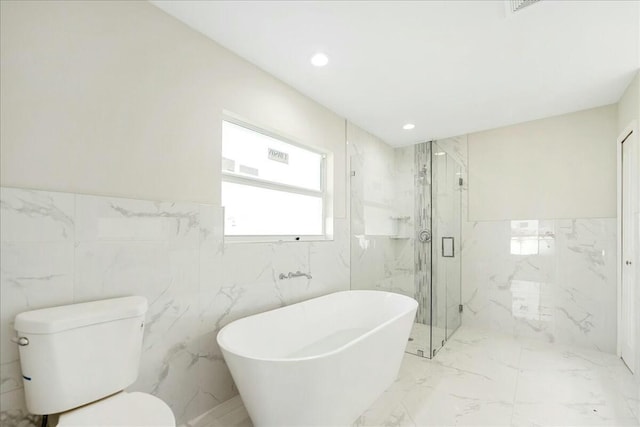 bathroom featuring toilet, tile walls, and independent shower and bath