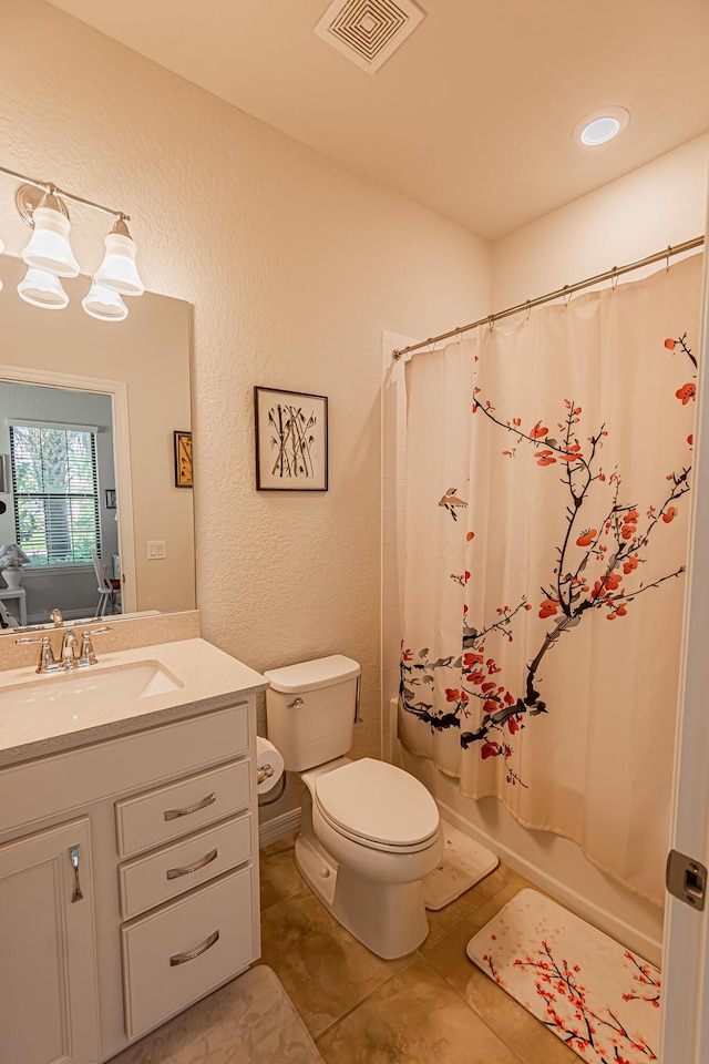 full bathroom featuring vanity, tile patterned floors, toilet, and shower / tub combo with curtain