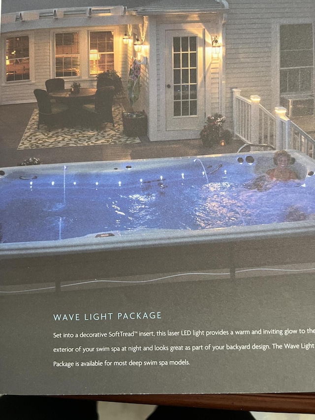 view of pool featuring a patio area and a hot tub