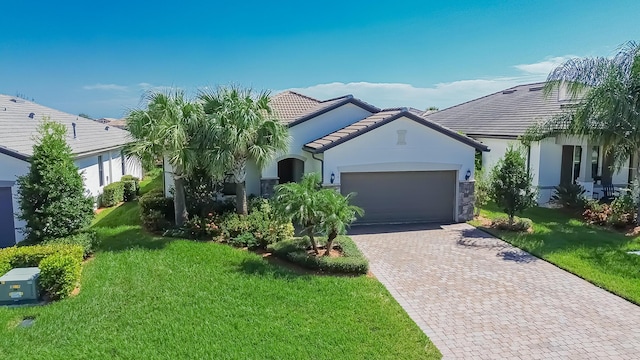 view of front of property featuring a garage and a front lawn