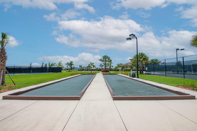 view of pool featuring a lawn