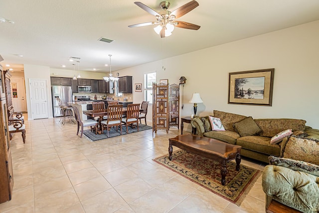 tiled living room with ceiling fan