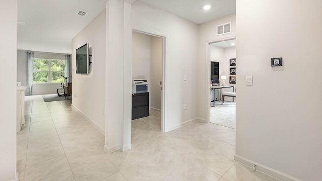 4601 SW Savona Blvd, Port Saint Lucie, FL 34953 - hall featuring visible vents, baseboards, and light tile patterned flooring