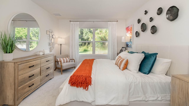 4601 SW Savona Blvd, Port Saint Lucie, FL 34953 - bedroom with light carpet, visible vents, and multiple windows