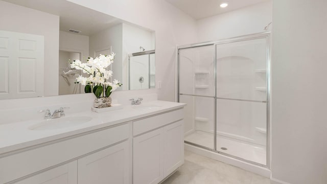 4601 SW Savona Blvd, Port Saint Lucie, FL 34953 - bathroom with double vanity, visible vents, a sink, and a stall shower