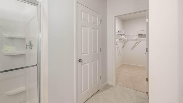 4601 SW Savona Blvd, Port Saint Lucie, FL 34953 - full bathroom with tile patterned flooring, a spacious closet, a stall shower, and baseboards