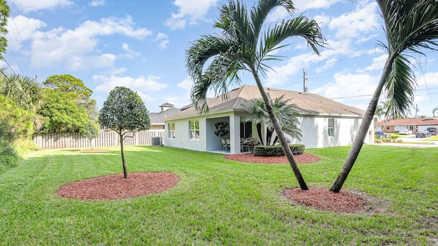 4601 SW Savona Blvd, Port Saint Lucie, FL 34953 - rear view of property with cooling unit, a yard, stucco siding, and fence