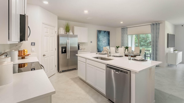 4601 SW Savona Blvd, Port Saint Lucie, FL 34953 - kitchen with white cabinets, a sink, light countertops, appliances with stainless steel finishes, and an island with sink