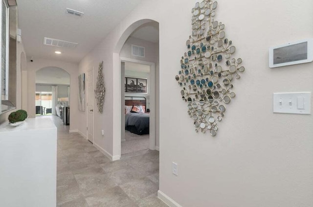 corridor featuring a textured ceiling