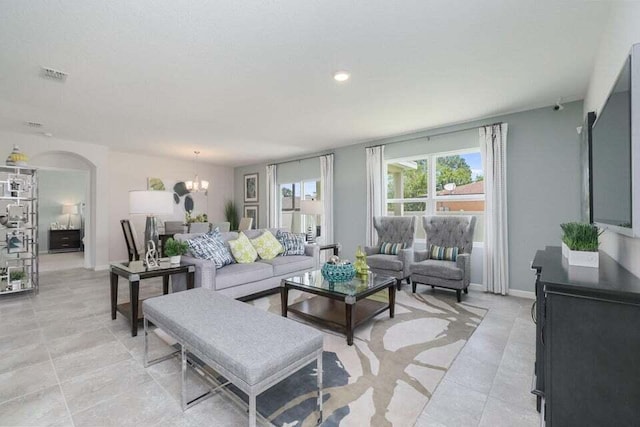 living room with a chandelier and light tile patterned floors