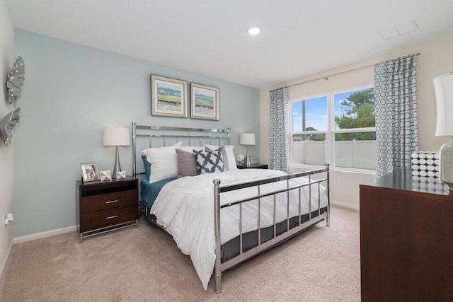 bedroom with light colored carpet