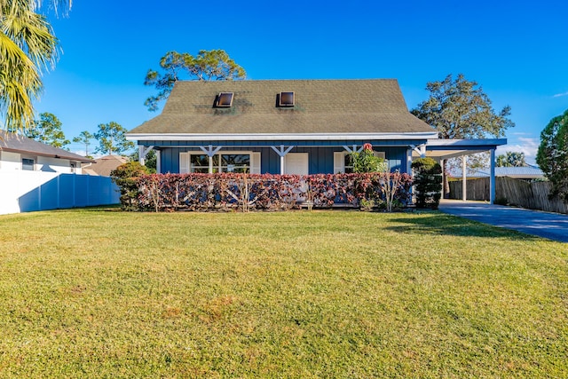 new england style home with a carport and a front yard