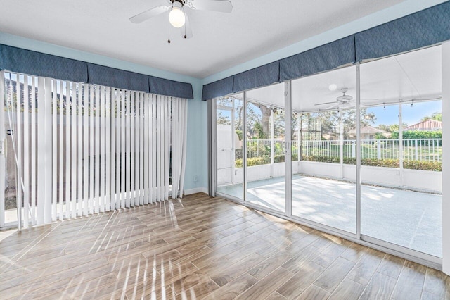 empty room with hardwood / wood-style floors and ceiling fan