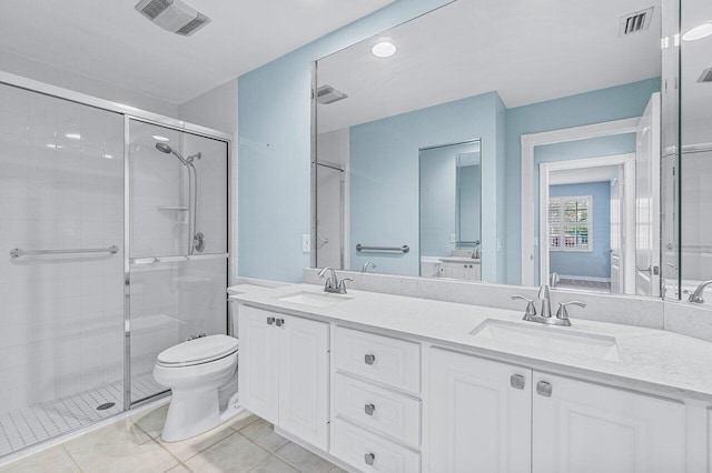 bathroom featuring tile patterned flooring, vanity, toilet, and an enclosed shower