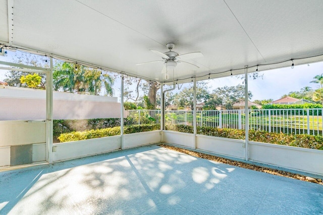 unfurnished sunroom featuring ceiling fan