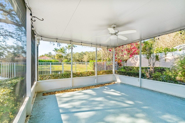 unfurnished sunroom featuring ceiling fan