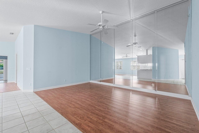 unfurnished living room featuring light hardwood / wood-style floors, a healthy amount of sunlight, and a textured ceiling