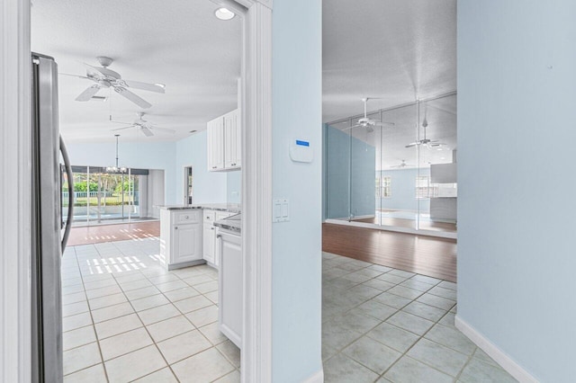 hallway featuring light hardwood / wood-style flooring and a textured ceiling