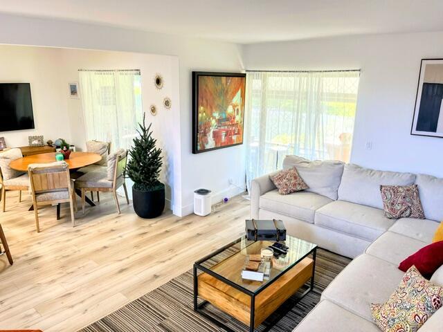 living room featuring light wood-type flooring and a wealth of natural light