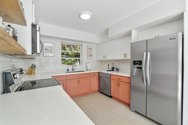 kitchen featuring white cabinetry, sink, appliances with stainless steel finishes, and tasteful backsplash