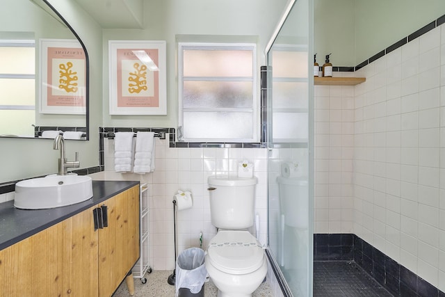 bathroom featuring walk in shower, a wealth of natural light, toilet, and tile walls