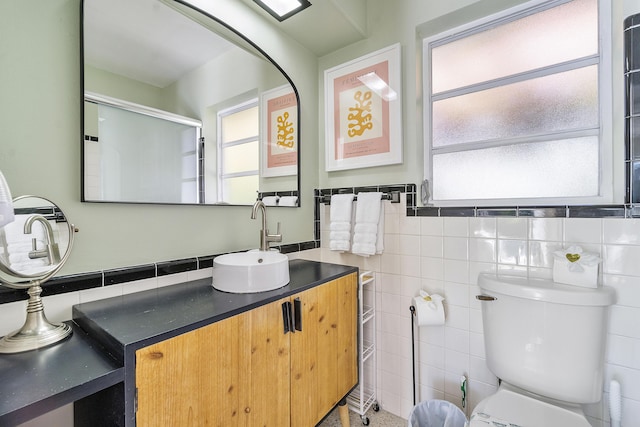 bathroom featuring walk in shower, a healthy amount of sunlight, tile walls, and toilet