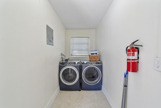 washroom featuring washing machine and clothes dryer and electric panel