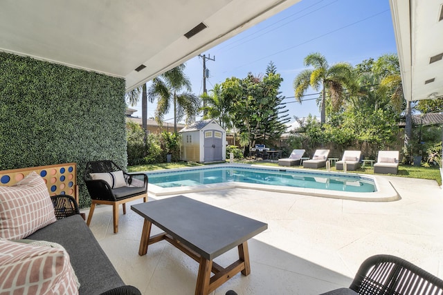 view of pool with a storage unit and a patio