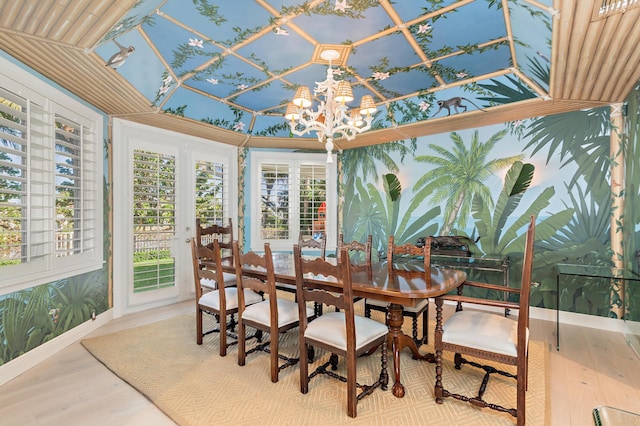 sunroom featuring a chandelier and lofted ceiling