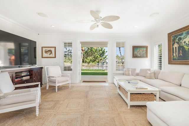 carpeted living room with ceiling fan and ornamental molding