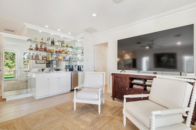 bar with white cabinetry, light hardwood / wood-style floors, and ornamental molding