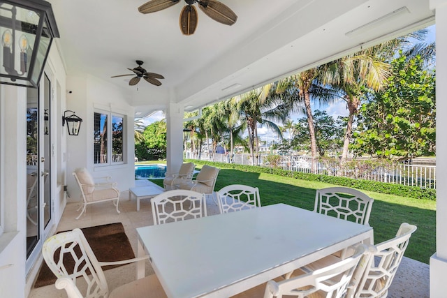 view of patio / terrace with a fenced in pool and ceiling fan