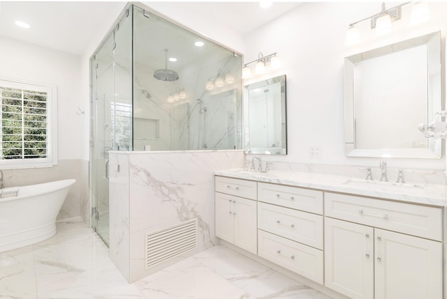 bathroom with vanity and independent shower and bath