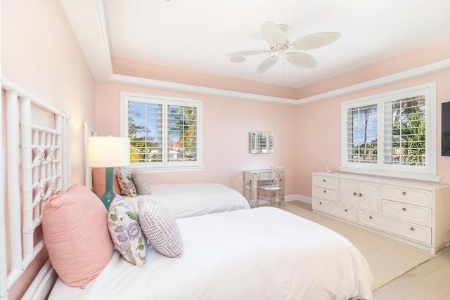 bedroom with light hardwood / wood-style floors, multiple windows, and ceiling fan