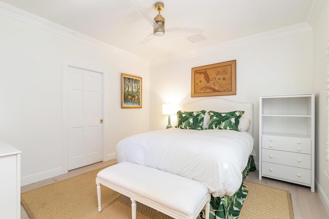 bedroom with ceiling fan, ornamental molding, and light hardwood / wood-style flooring