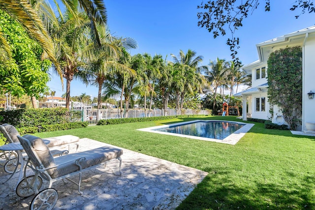 view of swimming pool featuring a yard and a patio