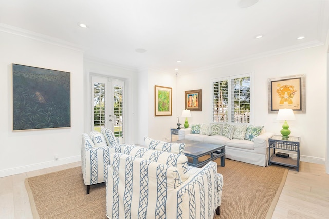 living room with light hardwood / wood-style floors, a wealth of natural light, and ornamental molding