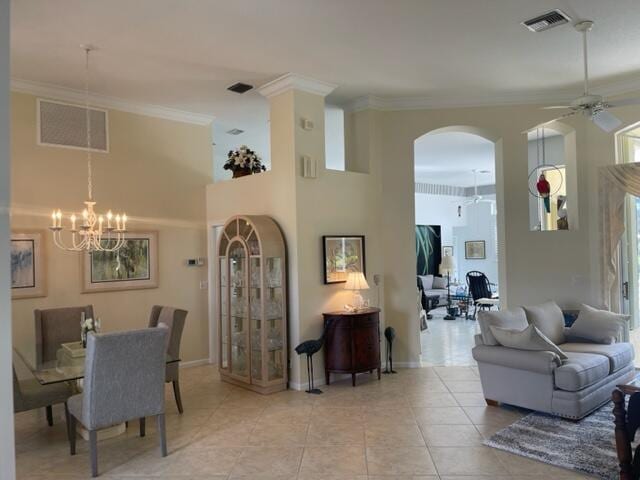 living room with visible vents, arched walkways, and crown molding