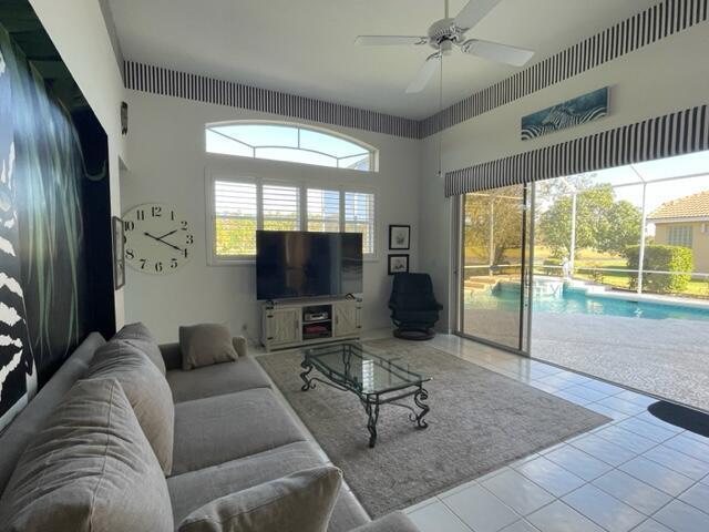 tiled living room featuring a ceiling fan