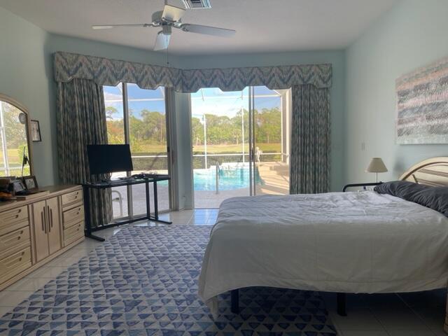 bedroom with light tile patterned floors, ceiling fan, and access to exterior