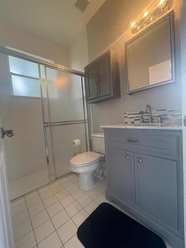 full bathroom with toilet, a stall shower, vanity, and visible vents