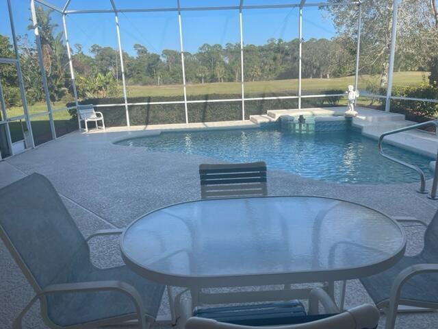 outdoor pool with a lanai and a patio