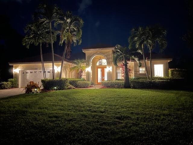 mediterranean / spanish-style house featuring a yard and driveway