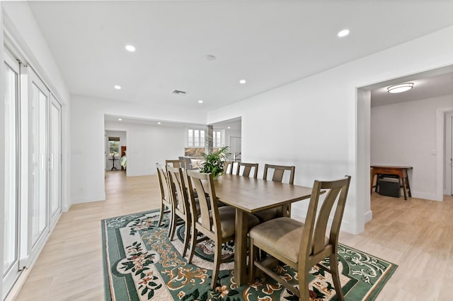 dining space featuring light wood-type flooring