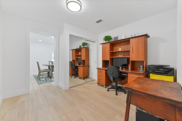 office with light wood-type flooring