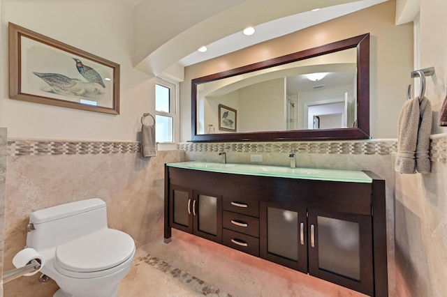 bathroom with tile patterned flooring, vanity, tile walls, and toilet